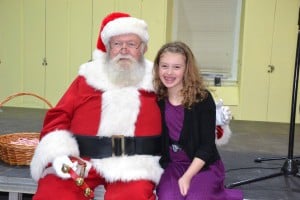 Jordan Budney smiles as she takes a few minutes to sit with Santa Claus.