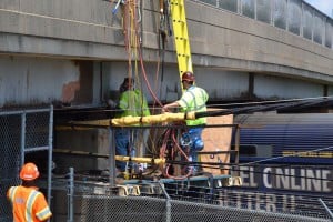 A train passes by workers sealing the White Horse Road bridge on Aug. 7. Work continued on the bridge for a few weeks, forcing the bridge to be closed to through traffic. Pedestrians, who could still use the bridge, enjoyed the wide-open lanes.