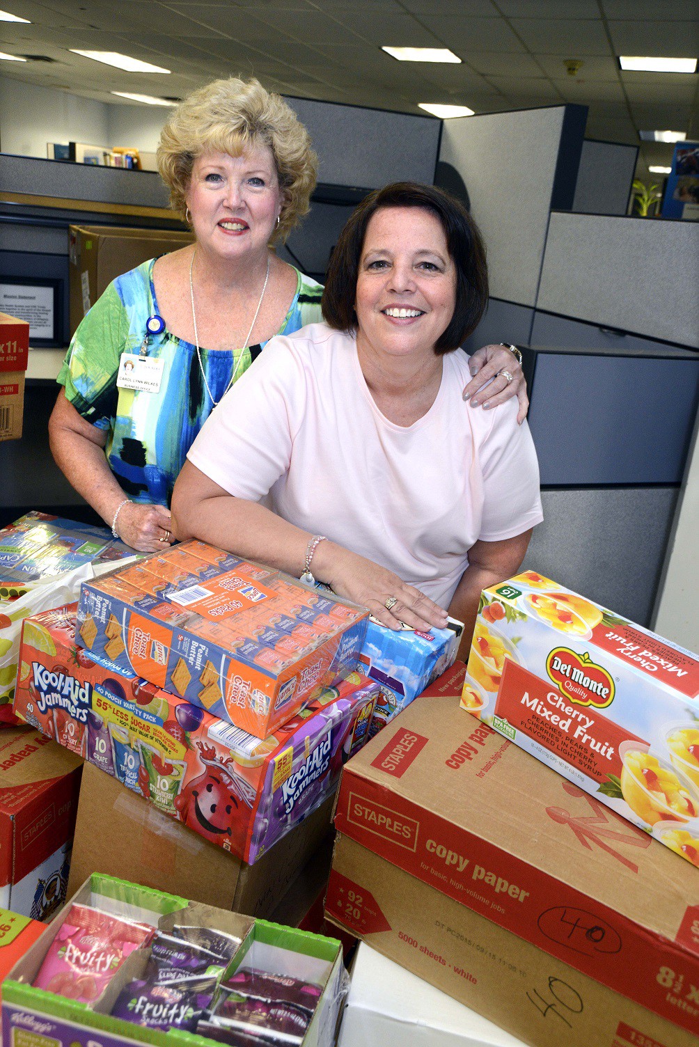 Lourdes’ Carol Lynn Wilkes (left) and Annette Gubernick gather food items to donate to Angels of God (AOG) Community Outreach Summer Food Program.