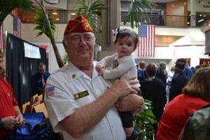 In honor of Bowman & Company’s 75th anniversary, the company decided to give back to the members of the community who fought for our freedom with a Veterans Day ceremony honoring 75 veterans from around the area on Nov. 11. Corporal Robert Sly of the Marine Corps League, pictured with his granddaughter Ella, helped to escort veterans during the ceremony.