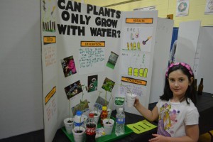 Sophia Evans, a 6-year-old kindergartener, did her project on weather plants would grow in liquids other than water. In addition to water, she used liquids such as milk, soda and more to grow plants and study the results. 