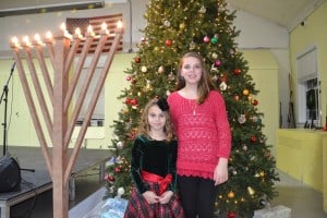 Ella and Christiana Lyras pose in front of Cherry Hill Township’s Christmas tree and Hanukkah menorah.