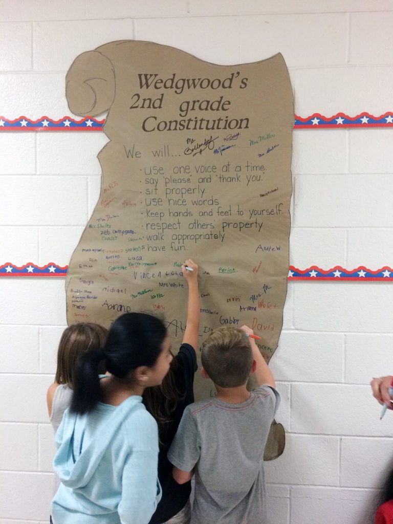 Wedgwood Elementary School second-graders sign their own Constitution in honor of National…